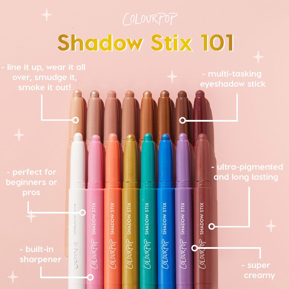 ColourPop Shadow Stix Hey Bestie glides-on eyeshadow stick shown among a rainbow lineup of creamy, ultra‑pigmented, long‑wear shades, tips uncapped to reveal texture, with built‑in sharpener and multi‑tasking use callouts on a soft pink backdrop.