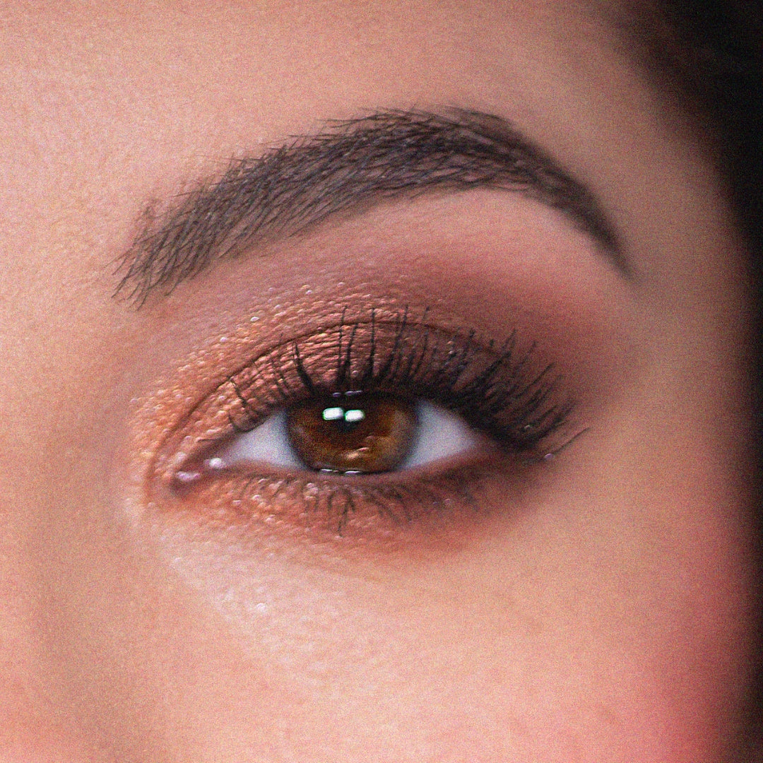 Warm copper and bronze shimmer eyeshadow sweeps across a brown eye with soft matte brown in the crease and fluttery lashes, highlighting an everyday glam look created with the Feelin Wild ColourPop Shadow Palette Set.