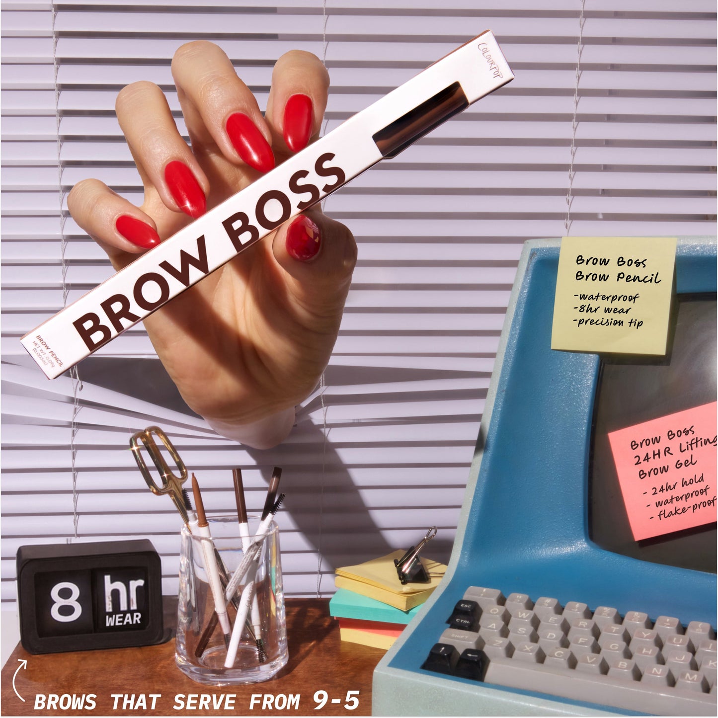 Hand with red nails holding ColourPop Brow Boss Pencil Taupe in office desk setup with retro computer, glass cup of brow pencils, and notes highlighting long-wear brow makeup benefits for all-day polished brows.