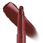 ColourPop Lippie Stix Infinite Best standing uncapped, displaying its rounded tip as a deep burgundy-brown swatch sweeps behind, showcasing creamy pigment payoff on a clean white background.