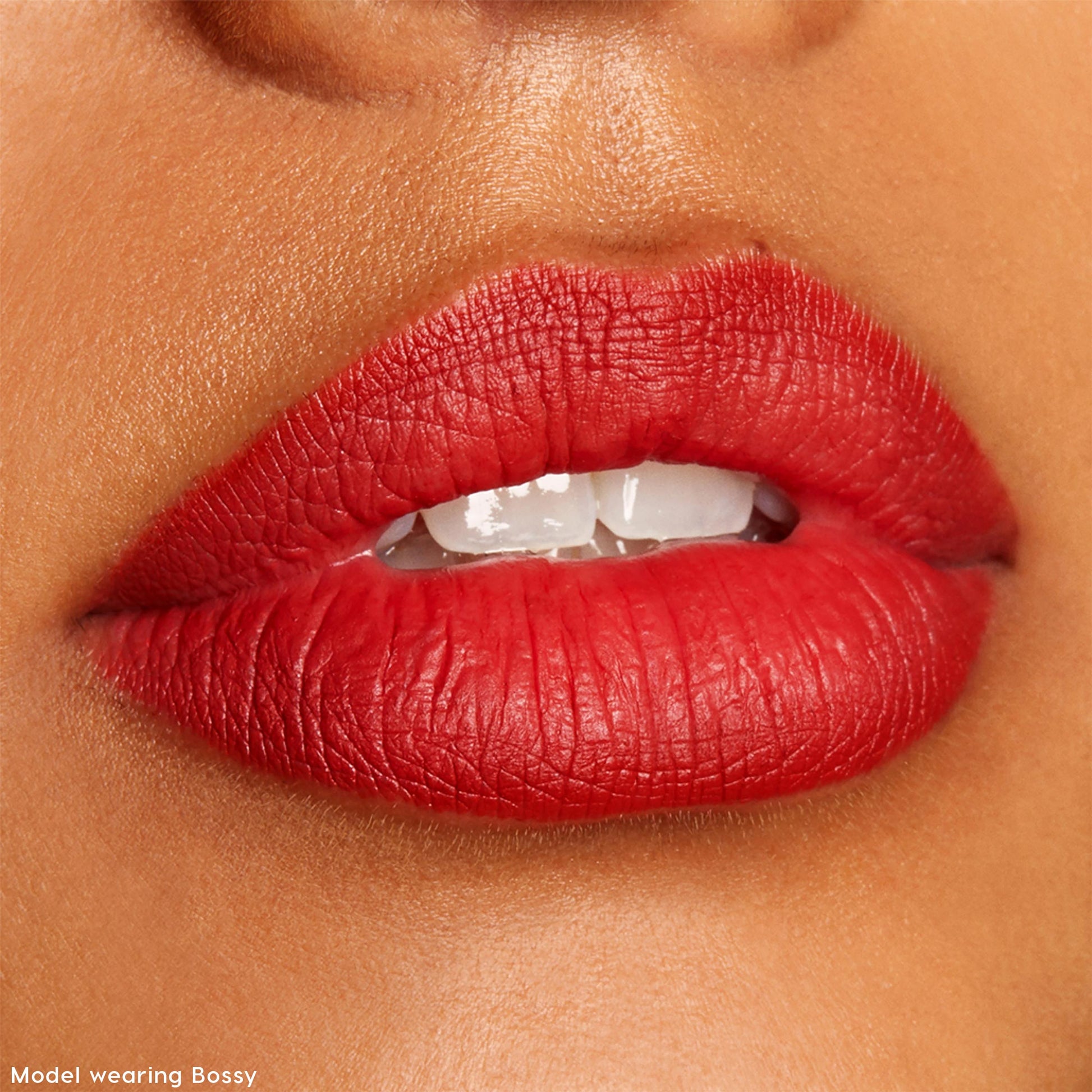 Bold red lips defined by ColourPop Lippie Pencil in Bossy, slightly parted to show teeth, in a tight studio close-up swatch for The Lil Box of Lippie Pencils, highlighting a smooth matte finish and crisp lip line.