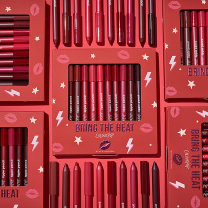 ColourPop Bring The Heat Lippie Pencil set arranged in a flat lay, showcasing creamy lip liners in reds, pinks, and berry tones; boxed and loose pencils surround the main kit on a red background with lips, stars, and lightning graphics.