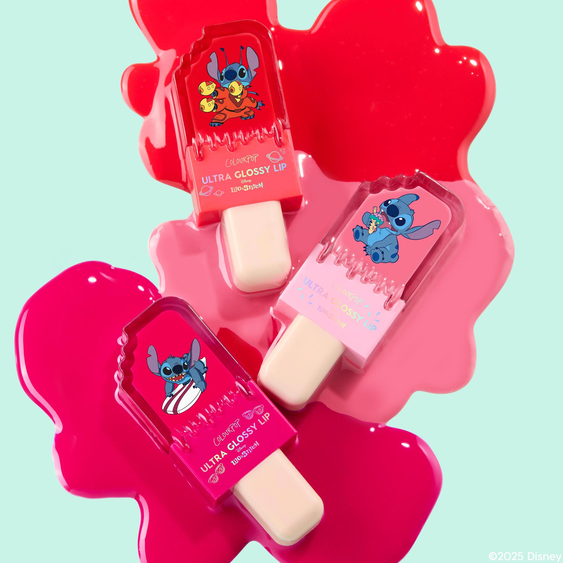 ColourPop Keepin’ It Sweet Ultra Glossy Lip trio shaped like popsicles featuring Disney Lilo and Stitch artwork, arranged on bright melted pink gloss pools against a mint background for a fun summer lip gloss display.
