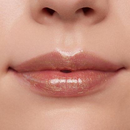 Glossed lips wearing ColourPop Ultra Glossy Lip in Pascal, a sheer clear gloss with gold micro-shimmer, reflecting studio light for a high-shine finish in a close-up beauty swatch.